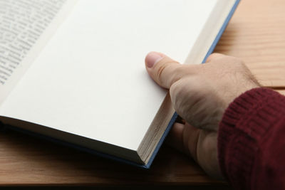 High angle view of man reading book on table