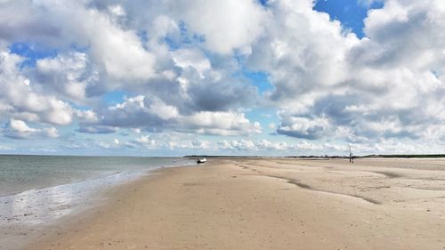 View of beach against cloudy sky