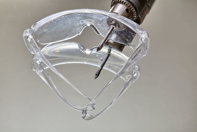 Close-up of glass over water against white background