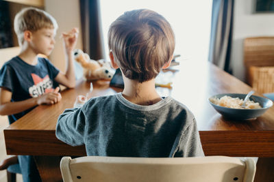 Boy sitting on table