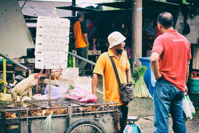 Rear view of men in city