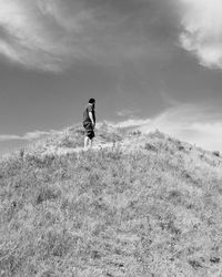 Man standing on mountain against sky