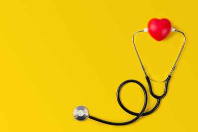 Close-up of heart shape against yellow background