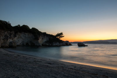 Scenic view of sea against clear sky during sunset