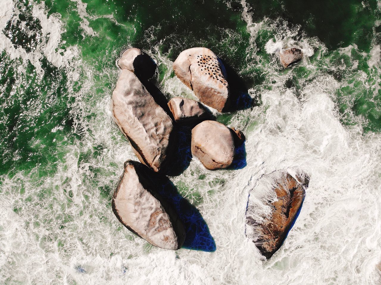 HIGH ANGLE VIEW OF SHOES ON BEACH