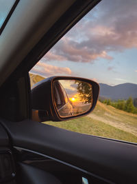 Low angle view of car on side-view mirror