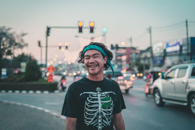 Portrait of a smiling young man in city