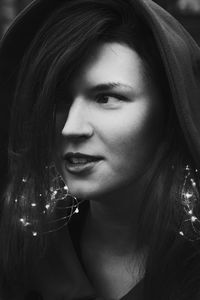 Close up young woman with lights garland monochrome portrait picture