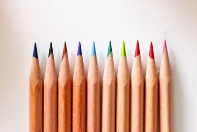 Close-up of colored pencils against white background