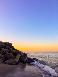 Scenic view of sea against clear sky during sunset