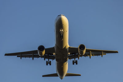 Low angle view of airplane against clear sky