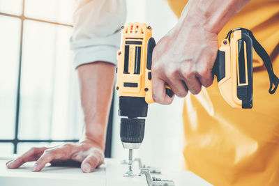 Midsection of man working in machine