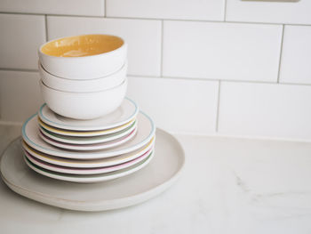 Stack of plates and bowls on table