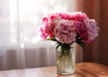 Close-up of flowers in vase on table at home