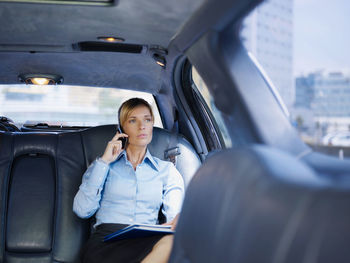 Portrait of woman sitting in car