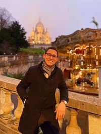 Portrait of man standing against built structures