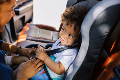 Mother with son sitting in car