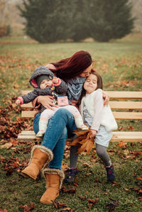 Full length of mother and girl on field