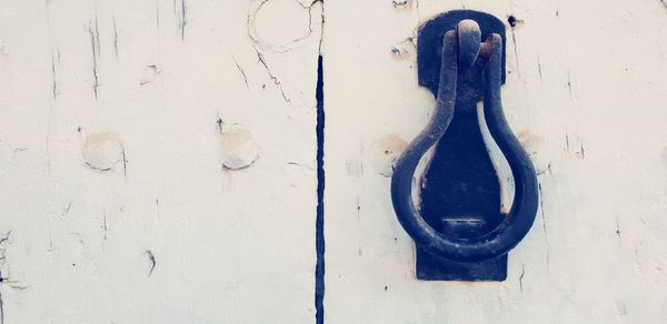 Close-up of door knocker on wall