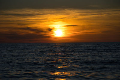 Scenic view of sea against romantic sky at sunset