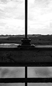 Close-up of metal structure on beach against sky