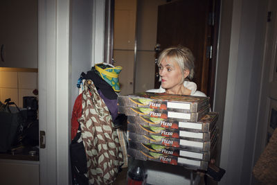 Woman carrying pizza boxes