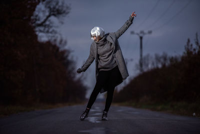 Woman with umbrella on snow covered road