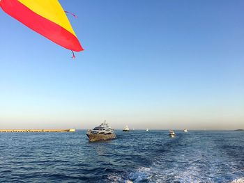 Sailboat sailing on sea against clear sky