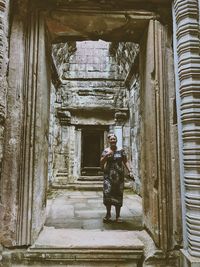 Woman walking in corridor of building