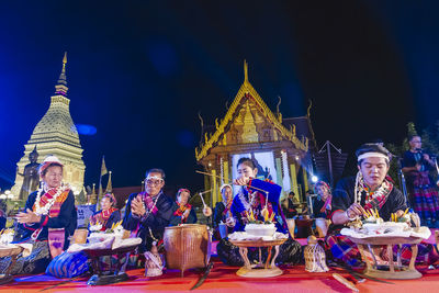 Group of people in front of building at night