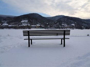Scenic view of lake against mountains during winter