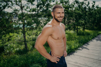 Shirtless muscular man standing outdoors