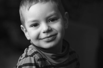 Close-up portrait of boy smiling at home
