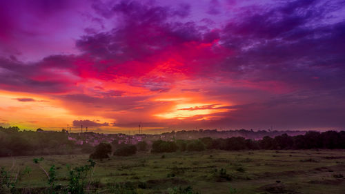 Scenic view of field against sky during sunset