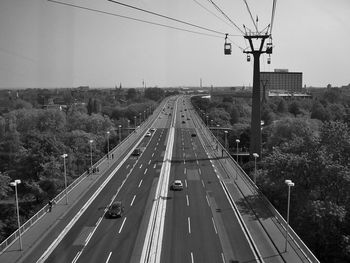 High angle view of cars moving on road amidst trees