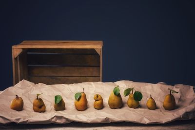 Ripe pear fruits on brown paper. ecological fruits in natural shapes, crooked or straight 