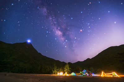 Scenic view of silhouette mountain against sky at night