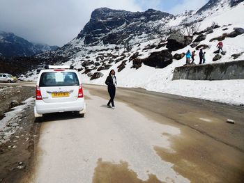 Tourists on snow covered mountain