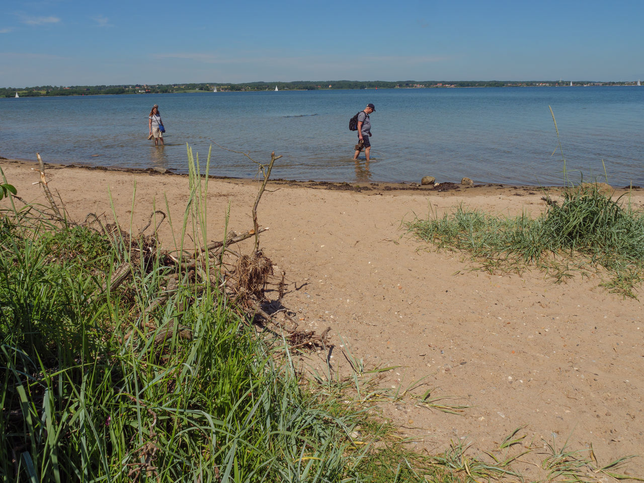 PEOPLE ON BEACH AGAINST SKY