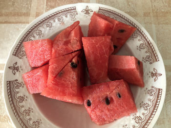 High angle view of chopped fruits in plate on table