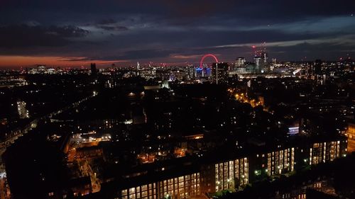 Illuminated cityscape against sky at night