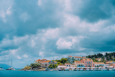 Panoramic view of buildings and sea against cloudy sky