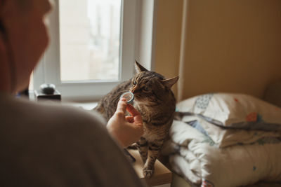 Man with dog on bed at home