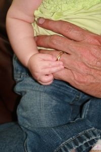 Close-up of father holding hands