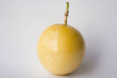 Close-up of lemon over white background