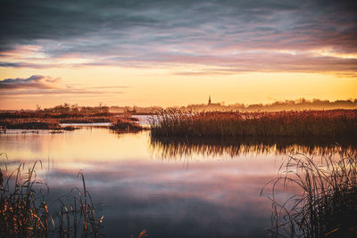 Scenic view of lake against sky during sunset