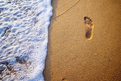 Close-up of footprint on beach