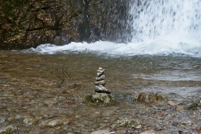 Man standing on rock by sea