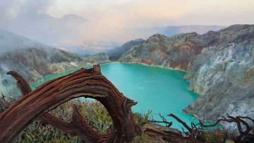 Scenic view of blue ijen crater against cloudy sky