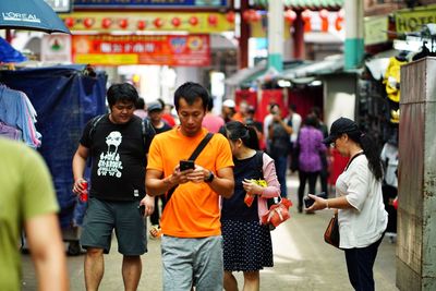 People walking on street in city